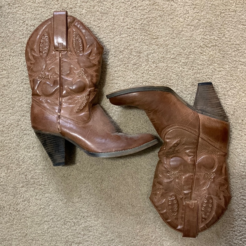 Heeled western style calf high boots.